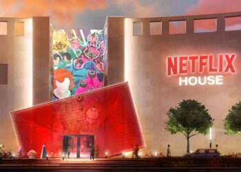 Exterior view of Netflix House theme park with futuristic red entrance and murals inspired by Netflix originals like Squid Game and Stranger Things.