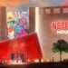 Netflix House Enters Theme Park Game to Rival Disney 2 Exterior view of Netflix House theme park with futuristic red entrance and murals inspired by Netflix originals like Squid Game and Stranger Things.