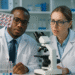 Revolutionary Combo Therapy for Achondroplasia Treatment 2 Two scientists in a modern laboratory reviewing digital imaging scans related to bone growth and genetic research for achondroplasia treatment.