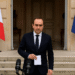 France PM Lecornu Resigns, Political Crisis Deepens 2 A French government official in a navy suit speaks at a press conference outside the Élysée Palace in Paris during daylight, with the French and European Union flags standing behind him.